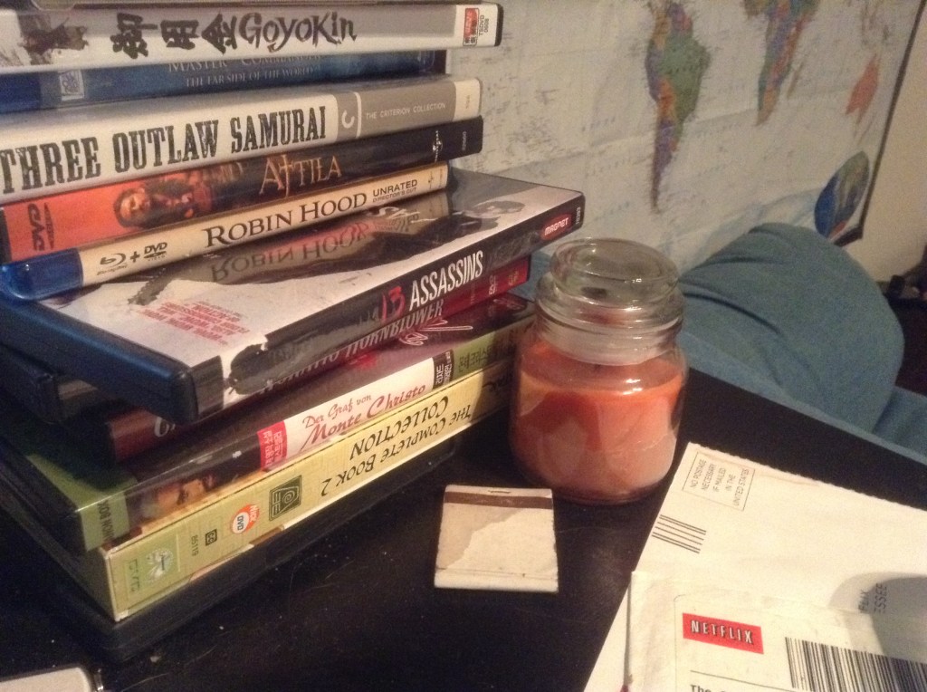 Here's the right side of my desk with some movies, a candle, my armchair, and a world map.
