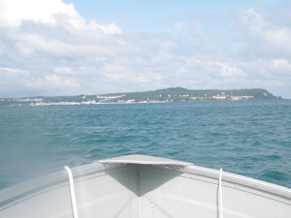 My uncle's piloting the family motor boat into Mackinac.